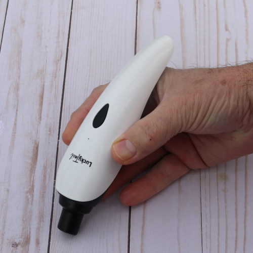 The Lucky Tail Nail Grinder is being held as if were a pencil