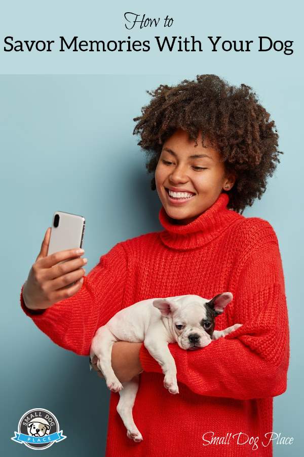 A woman is taking a selfie with her puppy
