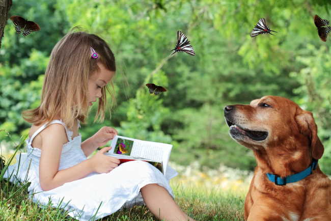 A young girl is reading to her dog.