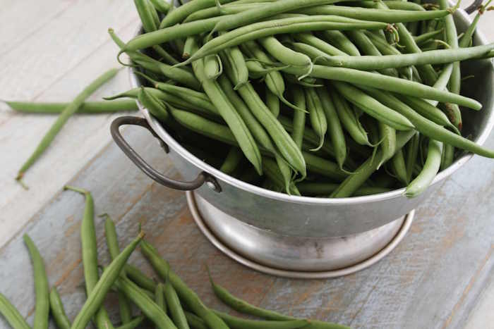 Fresh green beans on a wooden table