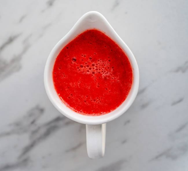 Cup of blended strawberry sauce