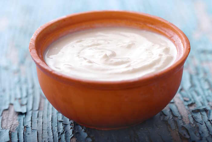 Bowl of yogurt on a wooden table